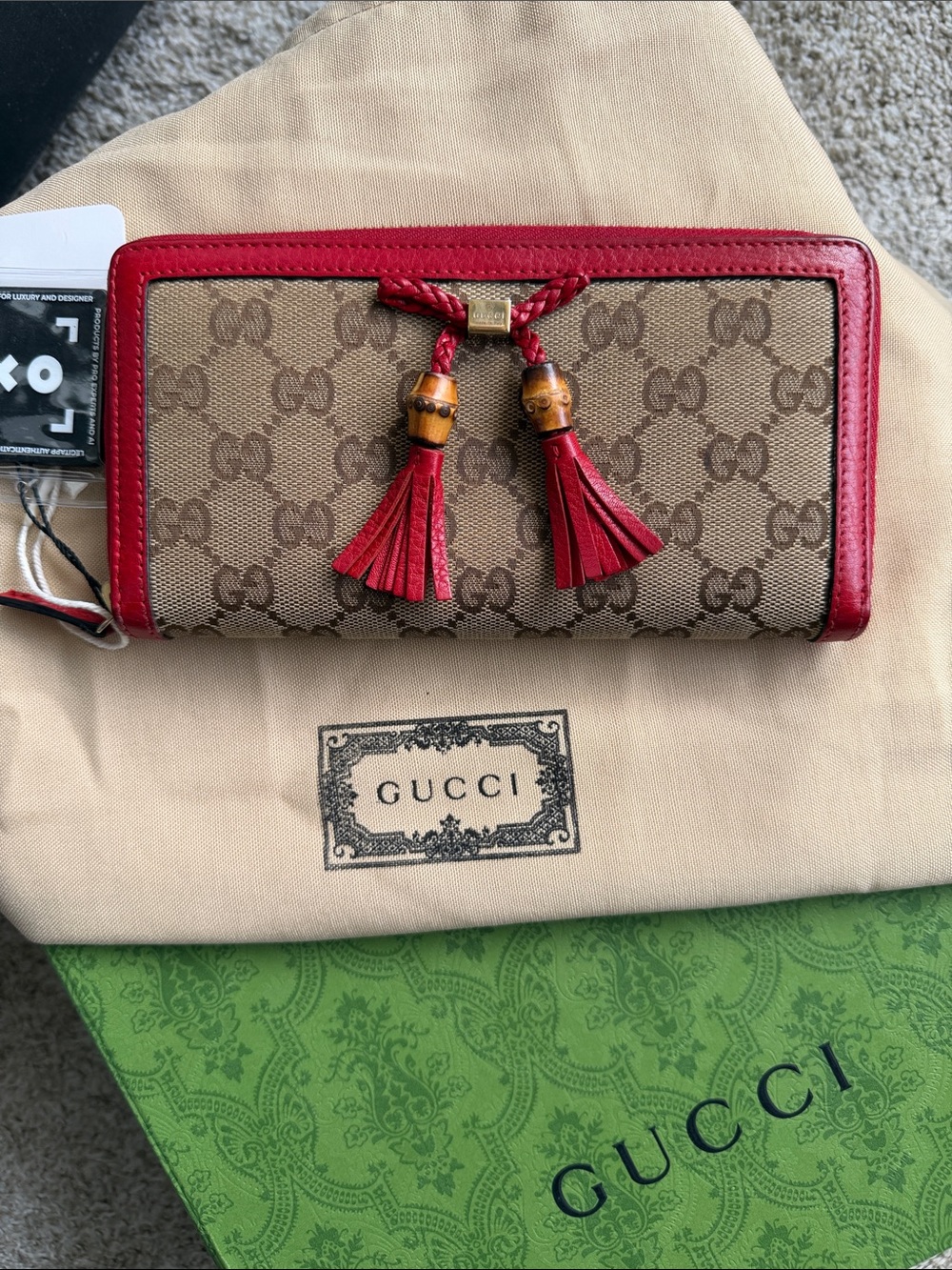 Gucci GG Canvas Continental Wallet in beige with bamboo tassels